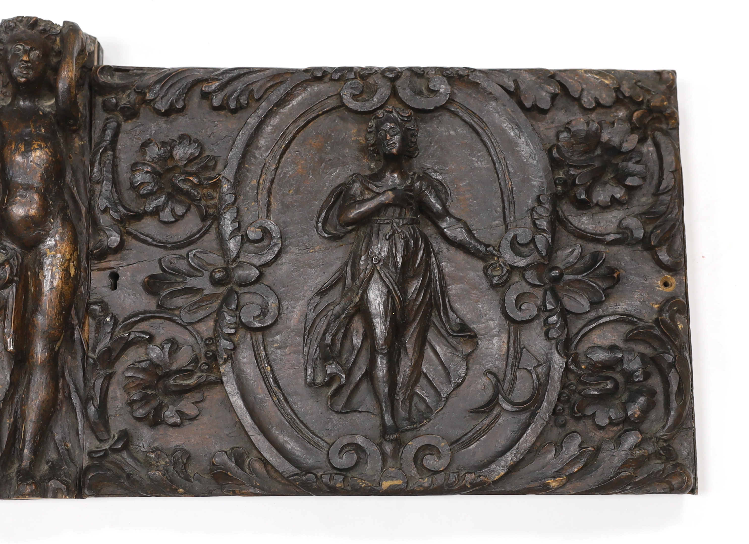 A 17th century French carved walnut triptych panel, 121cm wide, 37cm high